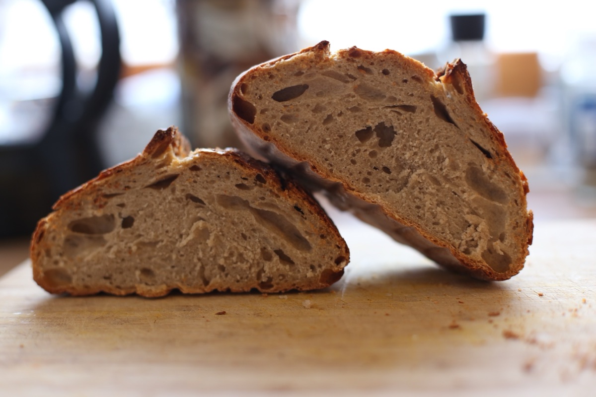A loaf cut in half, showing the crumb from the side